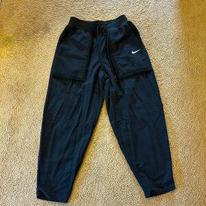 black nike pants, with faux fur on the pockets